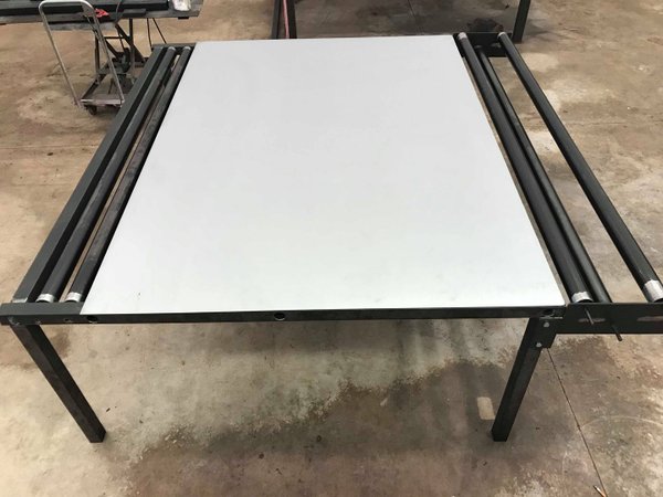 Fabric/Material cutting work table with roller dispensers
